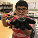 Boy holding large bubble